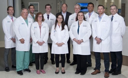 A group of doctors standing together
Description automatically generated